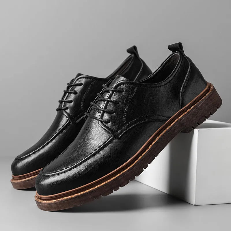 Men's black casual leather shoes with a round toe and flat rubber sole on a white background