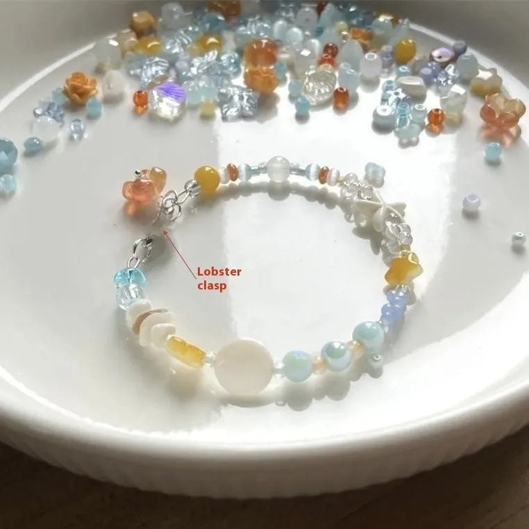 Orange diamond-shaped women's bracelet with round elements, made from mixed materials for summer seaside style.