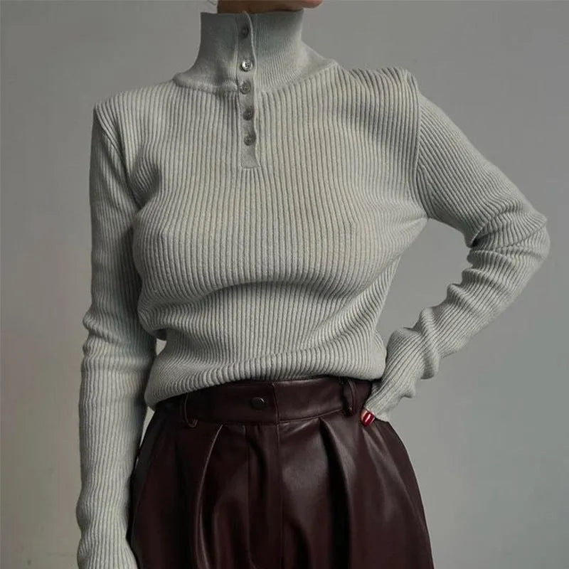 Slim fit silver grey half turtleneck sweater with a breasted button placket on a mannequin.