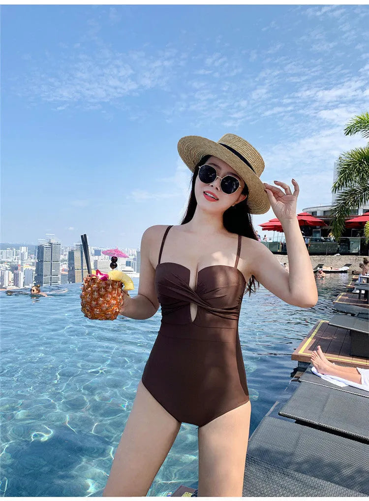 Brown one-piece swimsuit with spaghetti straps and push-up design on a mannequin