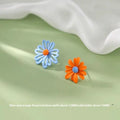 Three pairs of alloy flower earrings in blue-orange, white-green, and yellow-white colour combinations