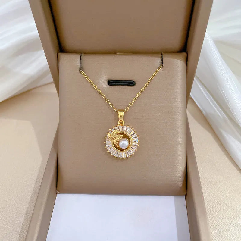 Women's geometric jewellery set with square diamond accents, ring and leaf motif on necklace and matching stud earrings.