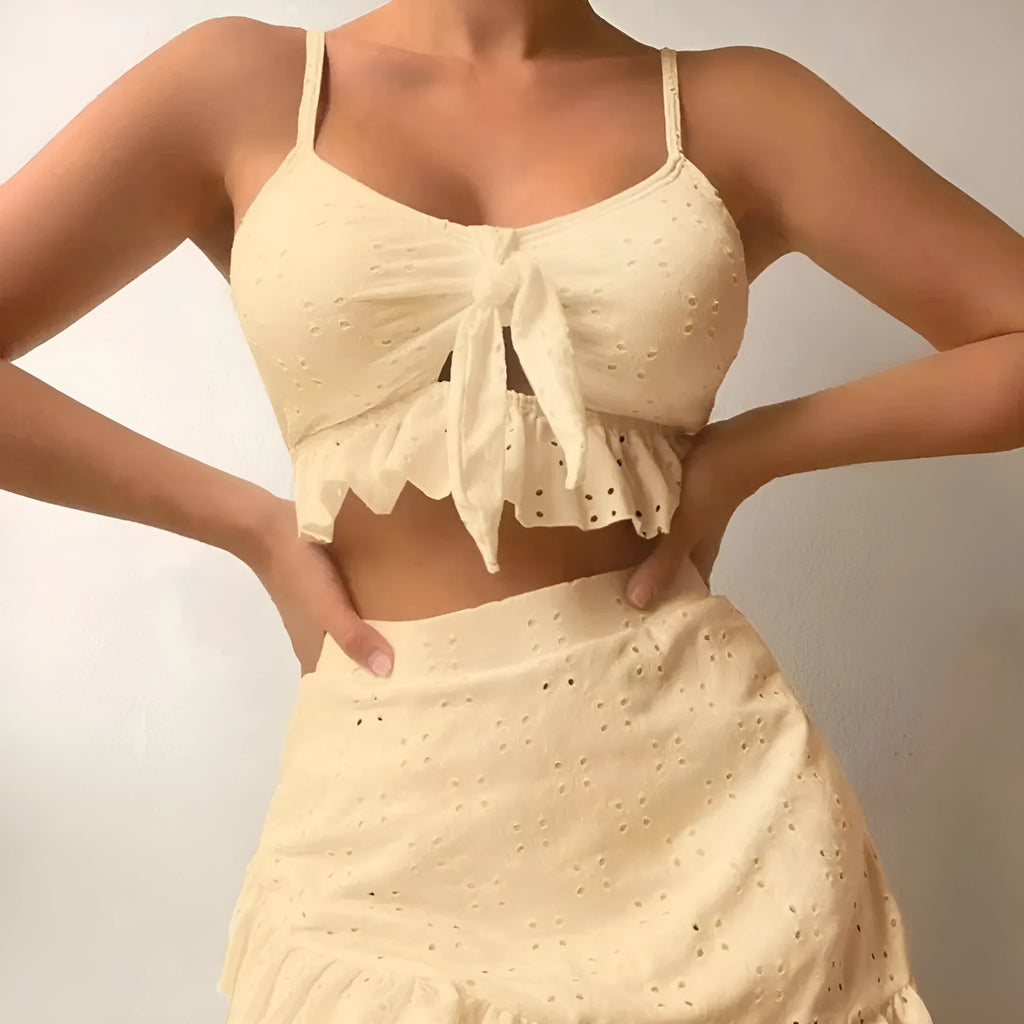 Women's white three-piece bikini set with a split hip skirt, made from polyester.