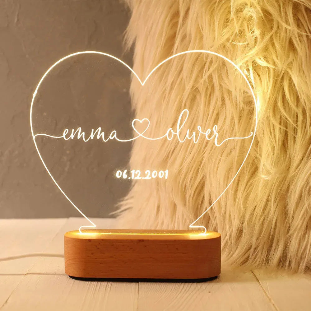 Personalised acrylic night light with engraved names and date, measuring 20cm by 11.5cm