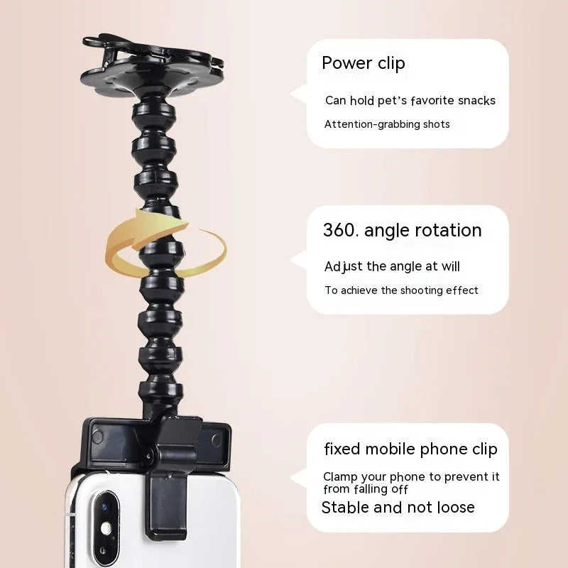 Black plastic pet photography clip holding a phone, with a rotating arm to grip dog or cat treats for photos.