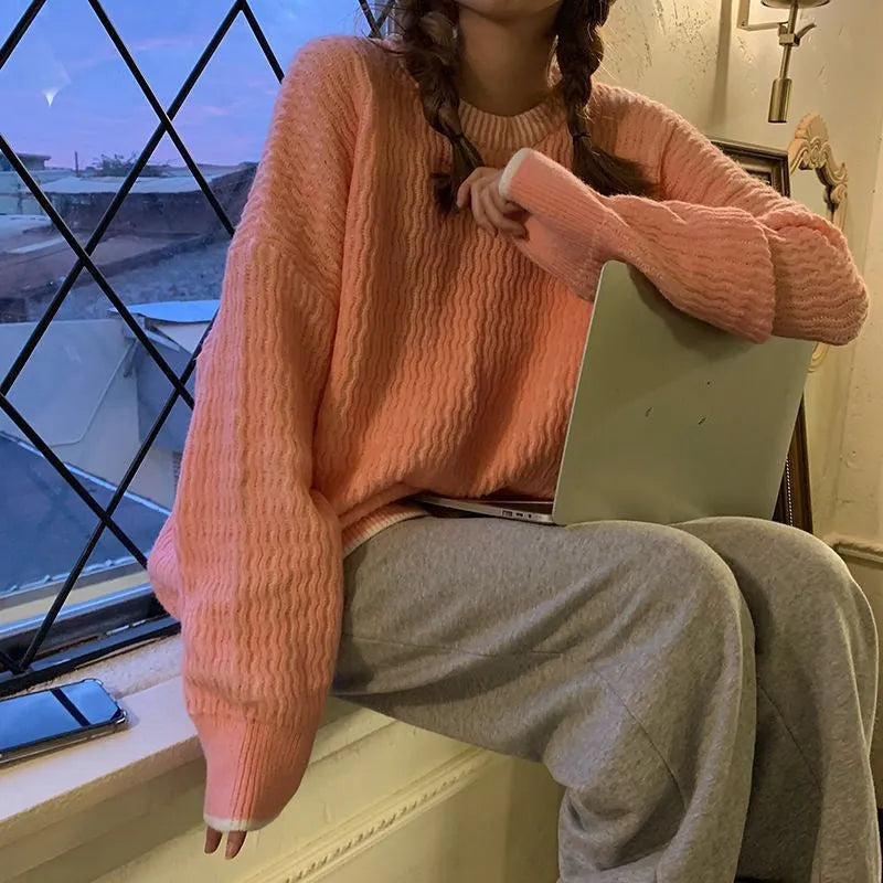 A lake blue loose-fitting women's retro pullover sweater with long sleeves on a hanger.
