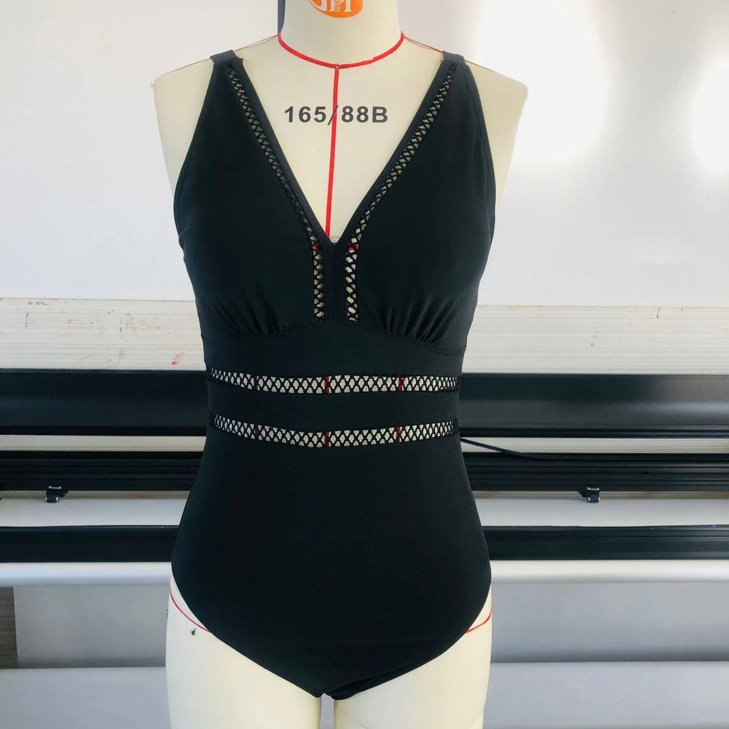 Women's black printed polyester plus-size bikini swimsuit shown on a hanger.