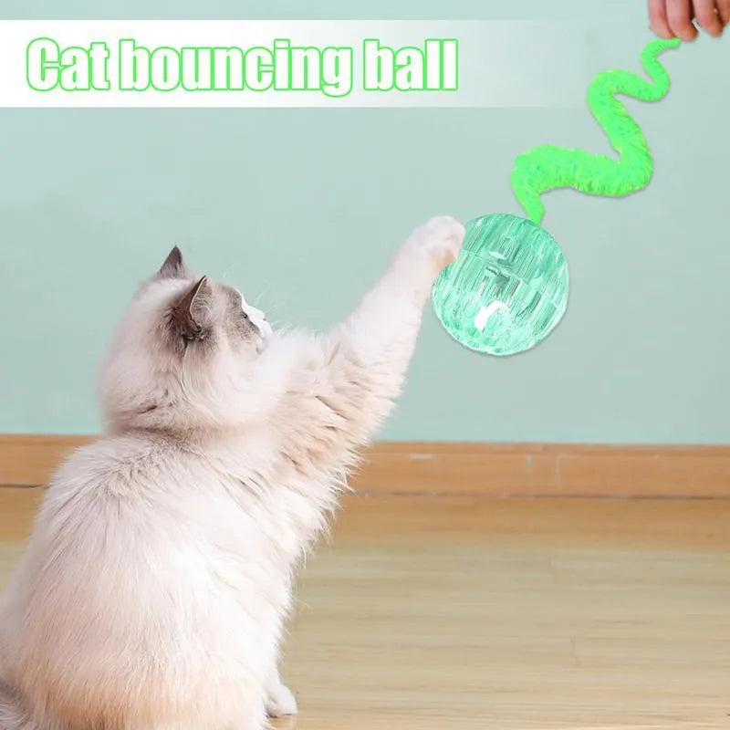 Green interactive bouncy ball cat toy with plush tail for indoor play