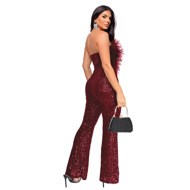 Women's black sleeveless backless jumpsuit with flared legs and sequin detailing.