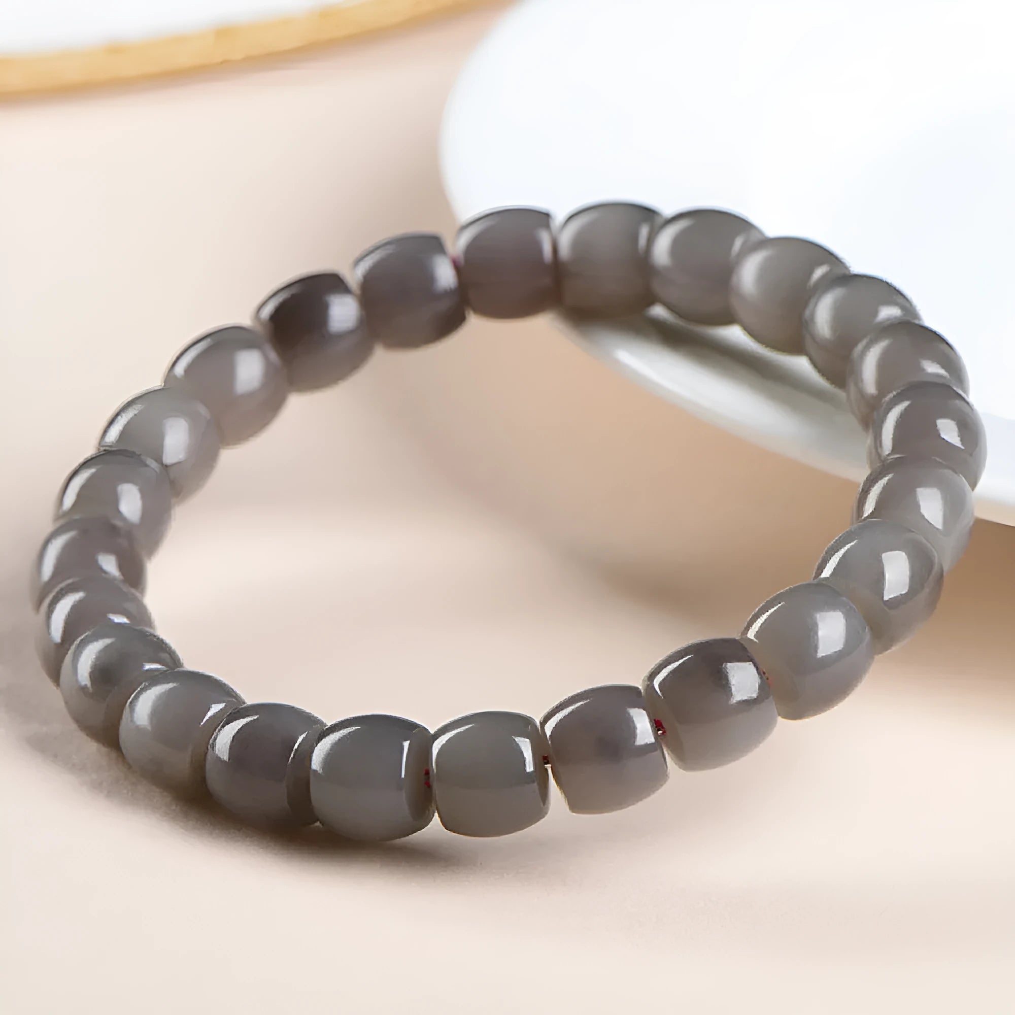 Natural Smokey Violet Hetian jade straight cut bracelet on a wrist, showing 8x9mm stones.