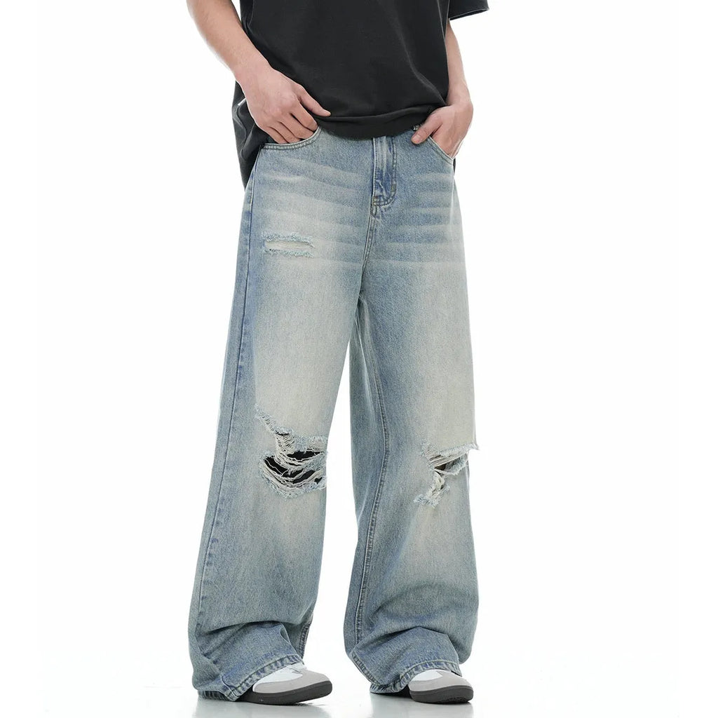 Blue men's straight-leg jeans with ripped details and a zipper fly, showing retro style.
