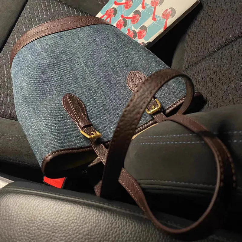 Denim patchwork one-shoulder bucket handbag showing 23x27x16cm dimensions and polyester construction