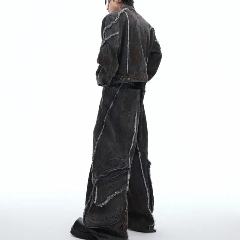Loose fit black splash-dye distressed denim coat with padded shoulders and matching pants on model