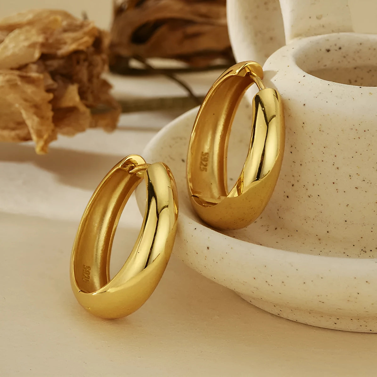 Pair of S925 sterling silver round hoop earrings with glossy electroplated finish in gold or white gold