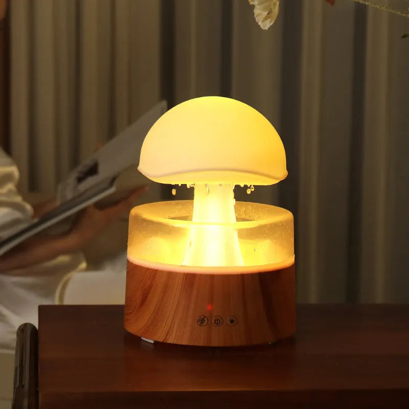 White cloud-shaped aromatherapy humidifier with LED lights and simulated raindrops.