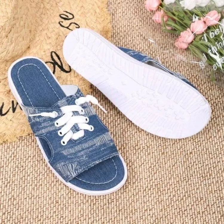 Blue Roman style women's canvas slippers with cloth upper and rubber sole.