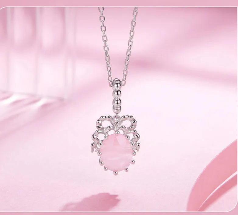 925 silver bow pendant with electroplated finish, height 2.4cm, width 1.2cm, on white background