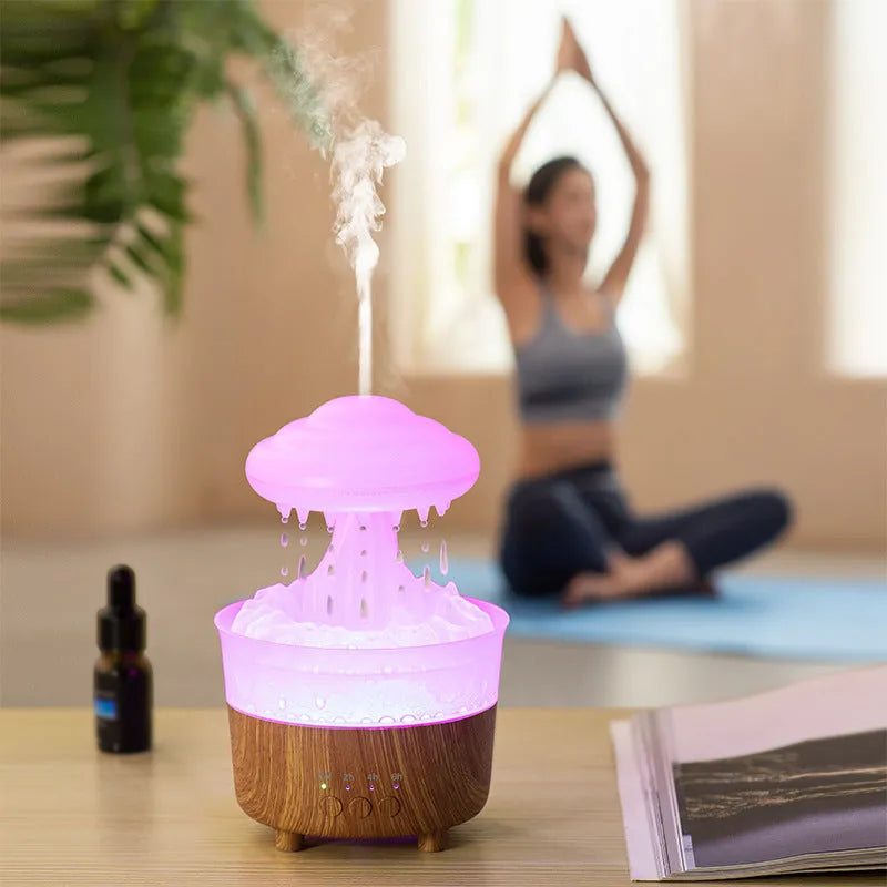 Wood grain white rain cloud shaped humidifier diffuser with LED night light on a table.