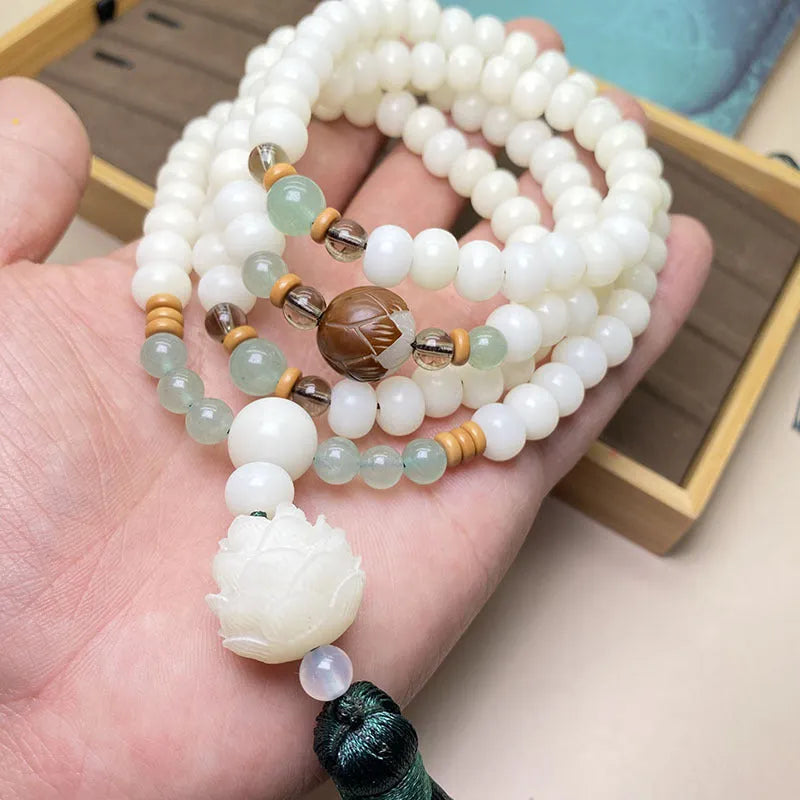 White Jade Bodhi beaded bracelet with 108 beads in a unisex design on a wrist.