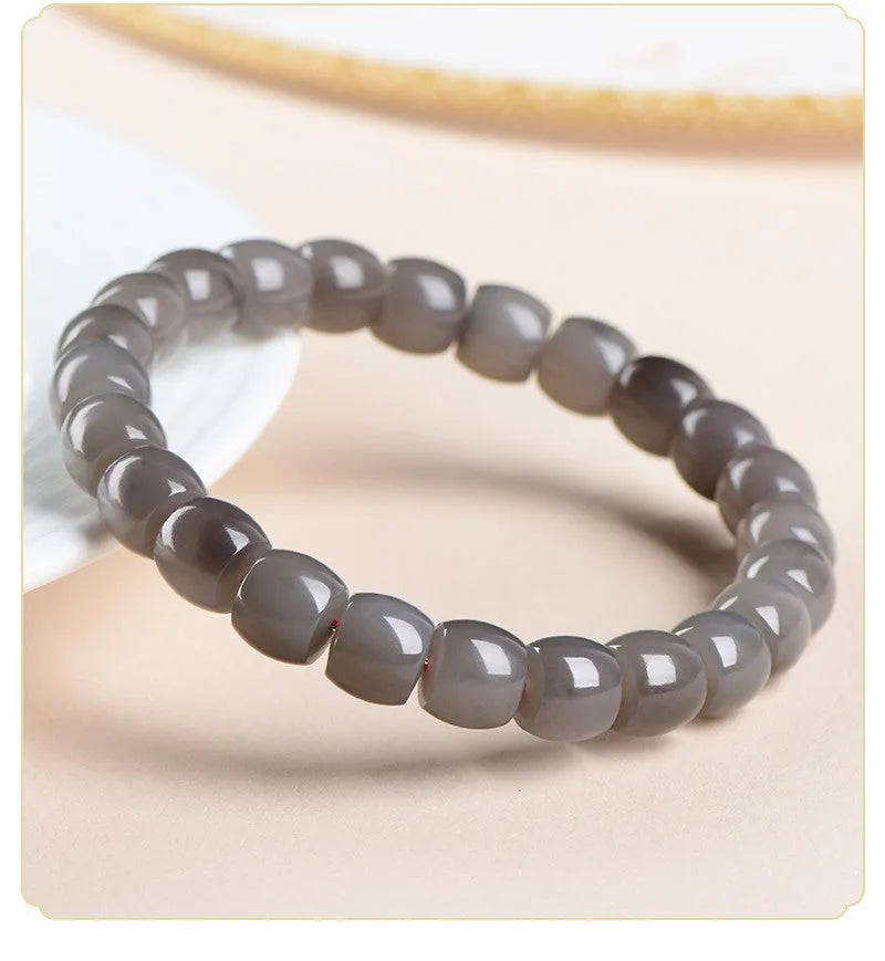 Natural Smokey Violet Hetian jade straight cut bracelet on a wrist, showing 8x9mm stones.