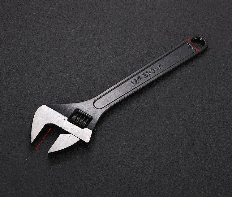 10-inch black high carbon steel adjustable open-end wrench on a workbench.