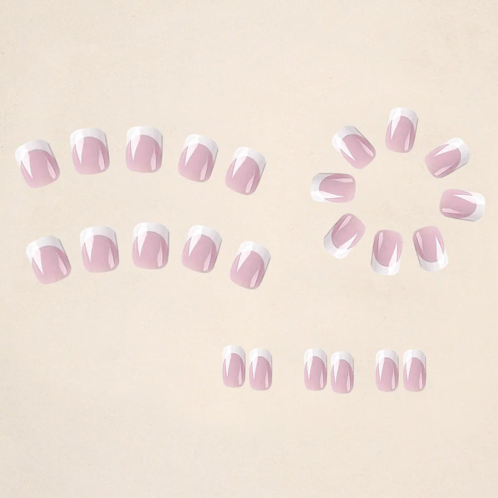 24 white square fake nails with a black and white plaid pattern arranged on a table.