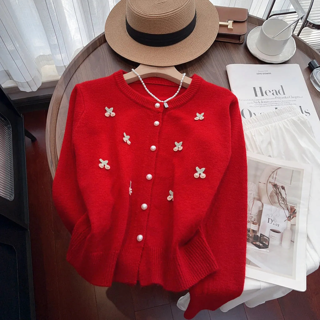Slim-fit cashmere blend sweater coat with beaded detail on a hanger, shown in blue colour.