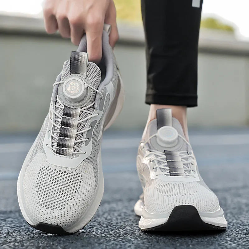 Men's white low-top running shoes with a rotating buckle closure and fly-knit mesh upper.