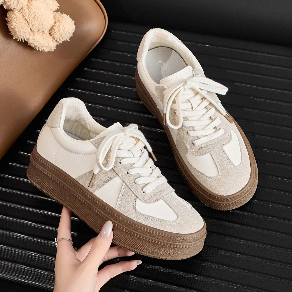 Retro-style beige casual board shoes with cross straps and round toe on a rubber sole.