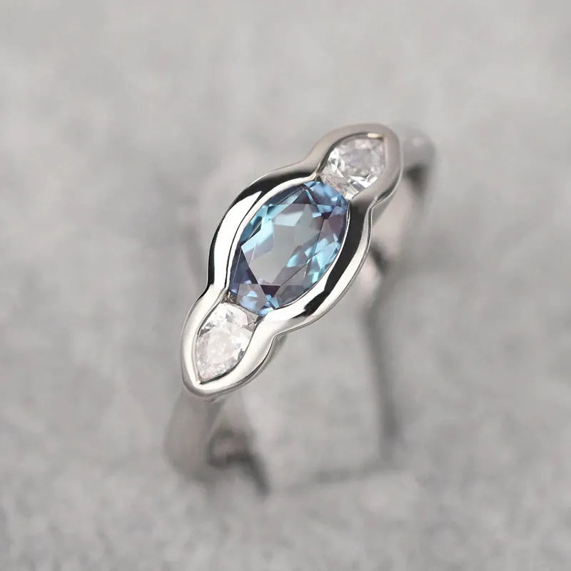 Geometric ellipse zircon ring in white gold finish on a copper band.