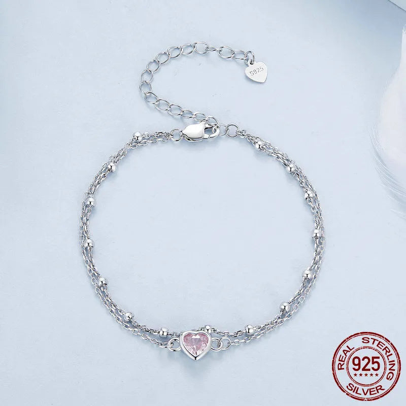Sweet girlish 925 sterling silver bracelet with small heart-shaped pendant on an adjustable chain.