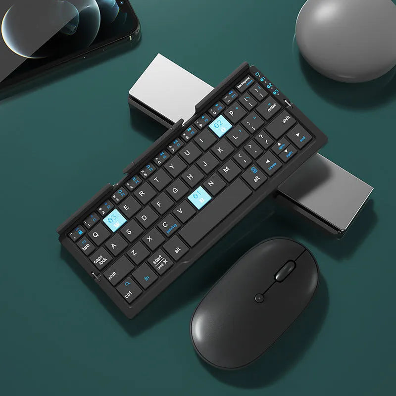 Silver folding Bluetooth keyboard open with phone standing in integrated holder