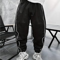 Men's loose fit cropped sports trousers in bamboo fibre fabric shown in army green colour.