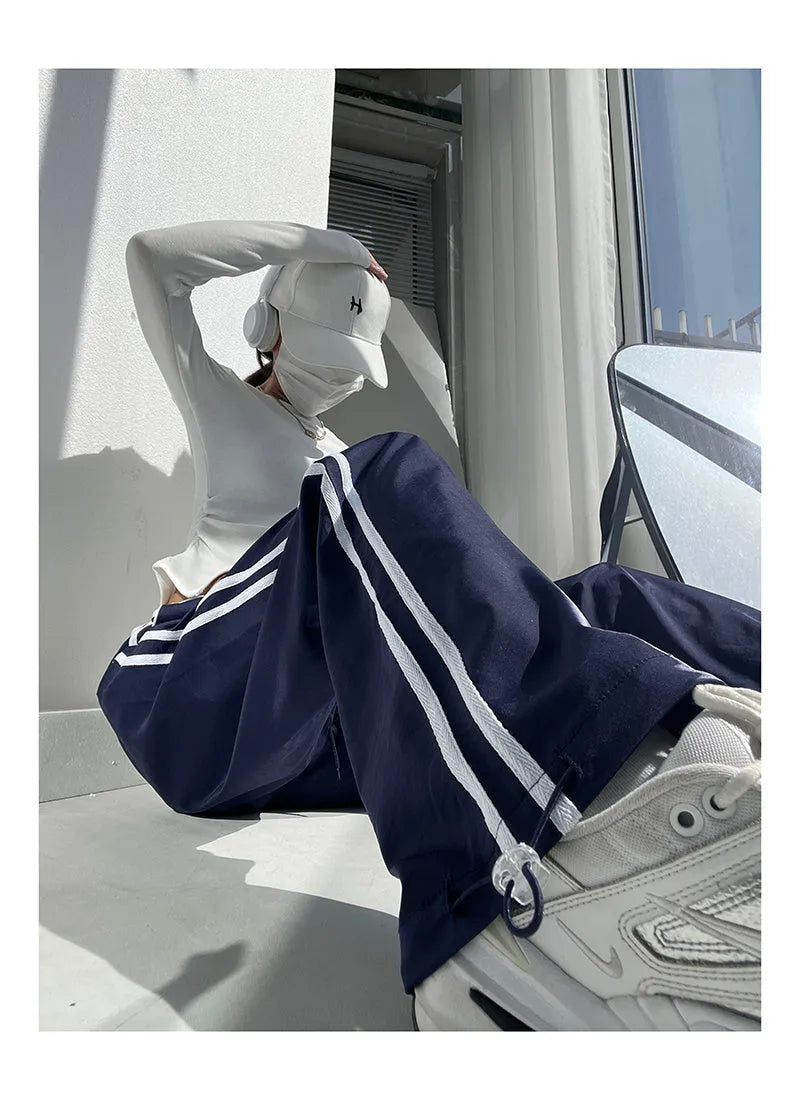 Women's loose straight-leg pants with ribbon parallel bar contrast detailing in navy blue colour option