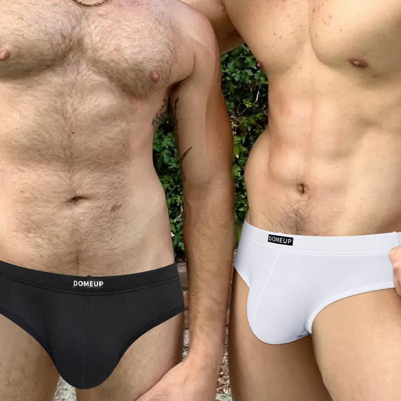 Men's solid colour seamless low-waist briefs in black, shown flat.