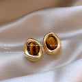 Handmade geometric holiday ear ring set showing three styles with tassel elements in different designs