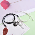 Pair of silver alloy magnet clasp couple bracelets showing example designs like clover, crown, and love symbols.