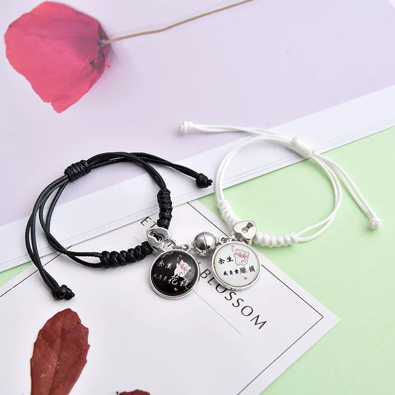 Pair of silver alloy magnet clasp couple bracelets showing example designs like clover, crown, and love symbols.
