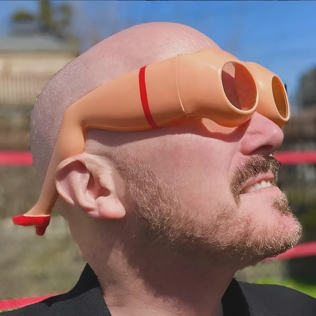 Orange novelty sunglasses with a personality leg and hip design on the plastic frame.