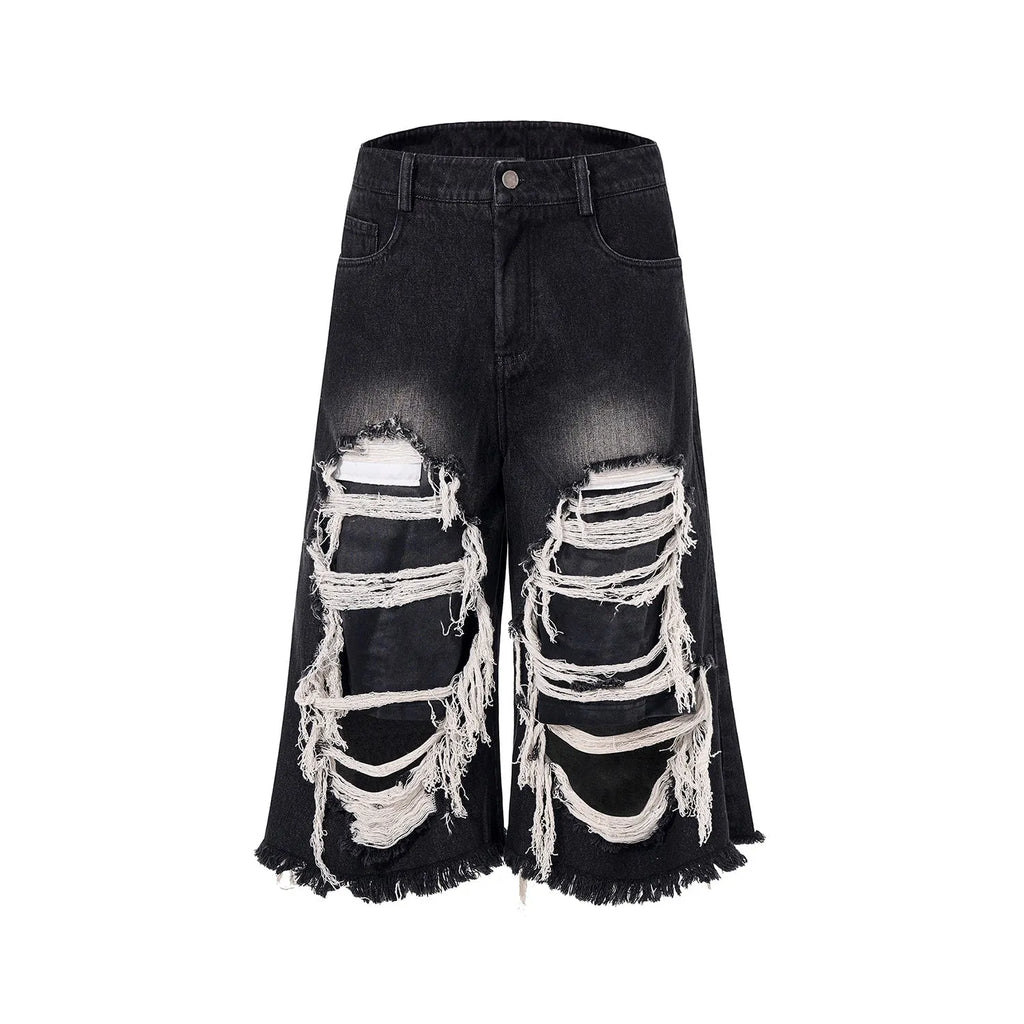 Black women's cropped wide-leg jeans with a ripped patch detail on the leg.
