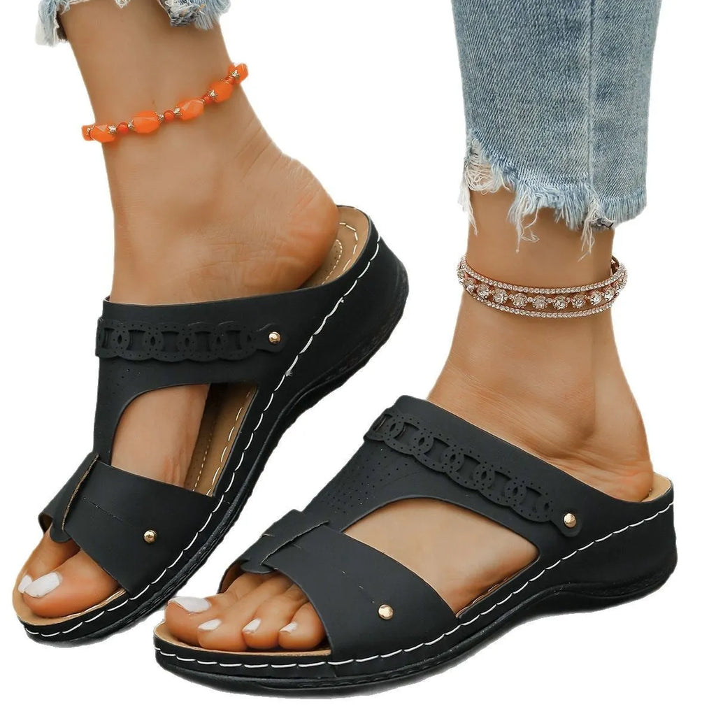 Blue Roman-style slippers with a fish mouth toe holder and slope heel on a rubber sole.
