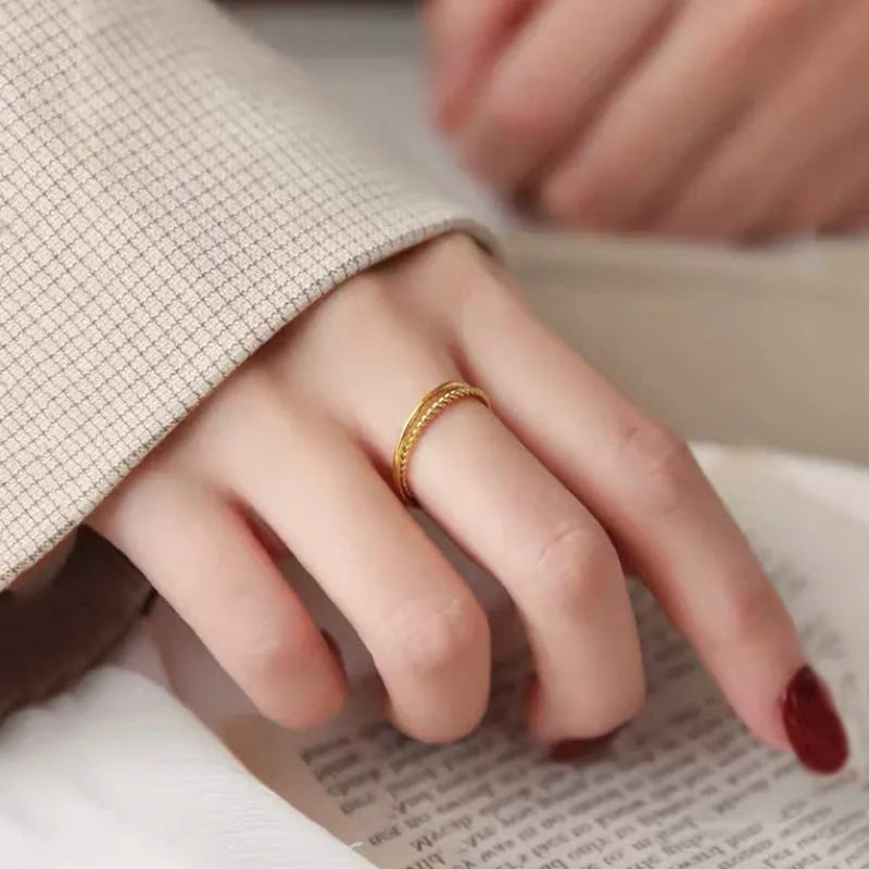 Brass gold plated women's ring showing twist, matte and glossy simple bracelet styles