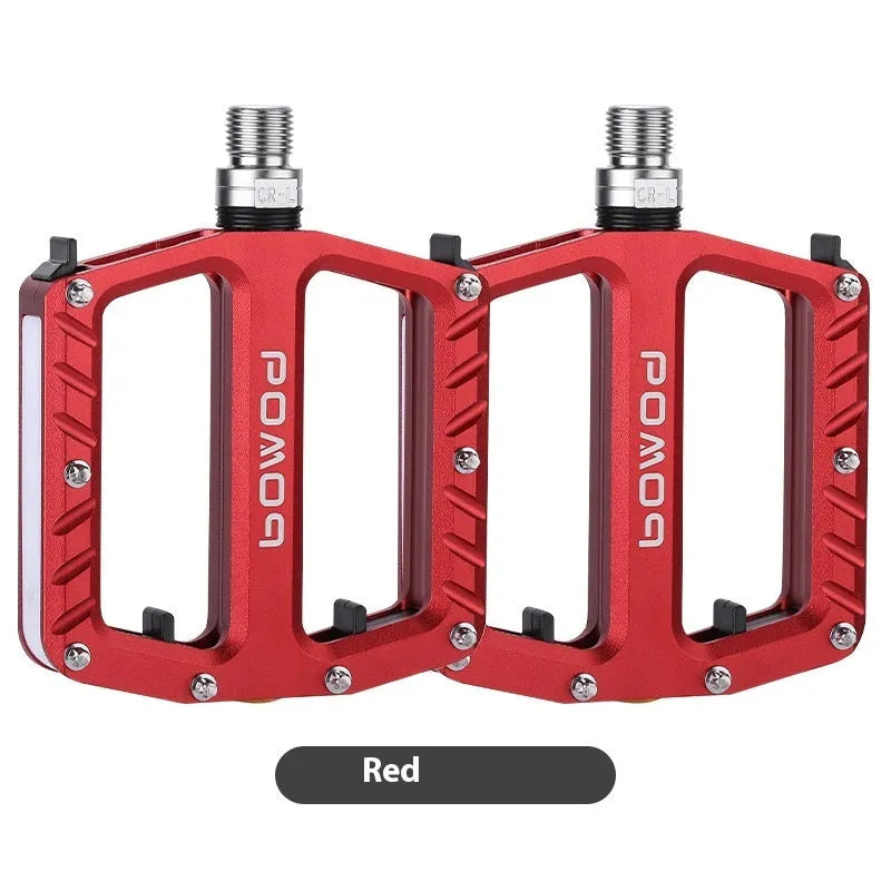 Pair of aluminium alloy bicycle pedals with integrated LED lights in multiple colour options.