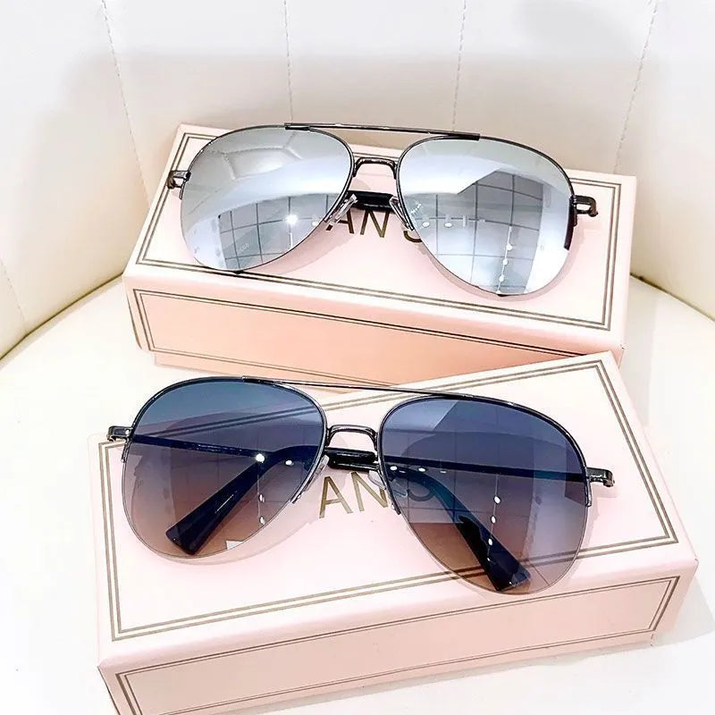 Aviator-style sunglasses with a metal frame and tinted resin lens, shown in a gold frame variant.