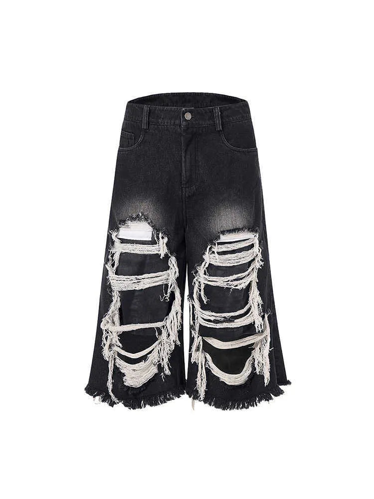 Black women's cropped wide-leg jeans with a ripped patch detail on the leg.