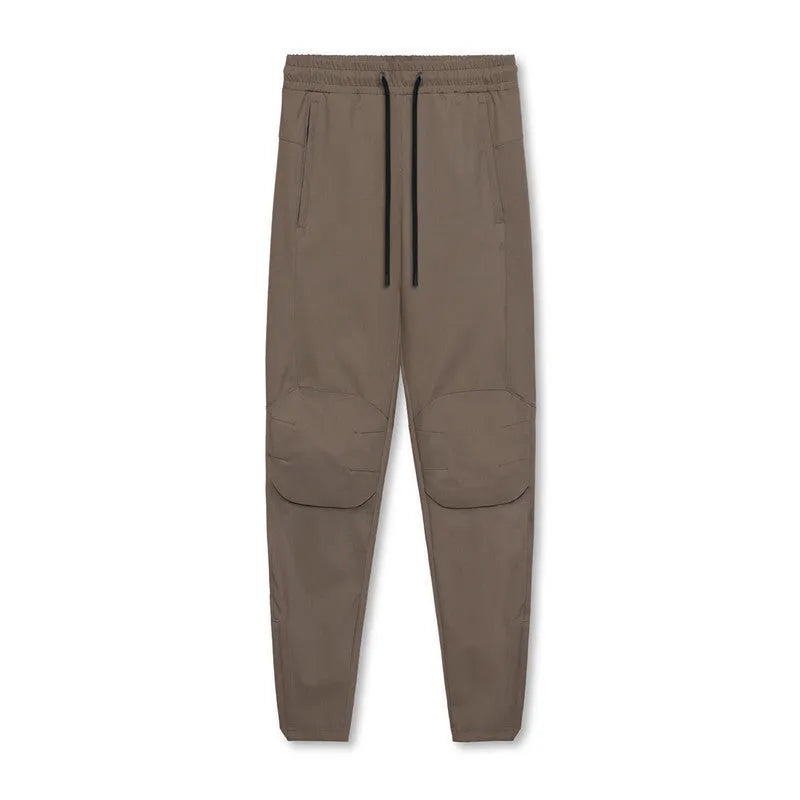 Men's dark grey quick-dry ankle-tie fitness pants shown in a loose fit.