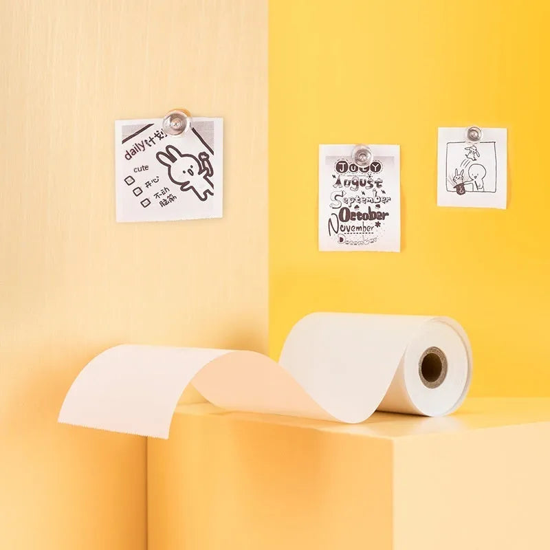 Three rolls of 57mm by 30mm thermal paper in an open box.