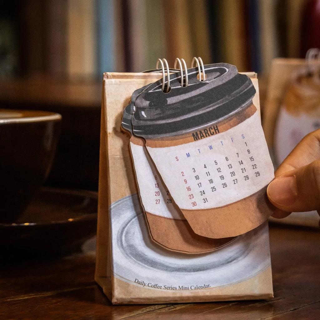 Mini 2025 desk calendar set showing four different themed designs including coffee and motivational messages.