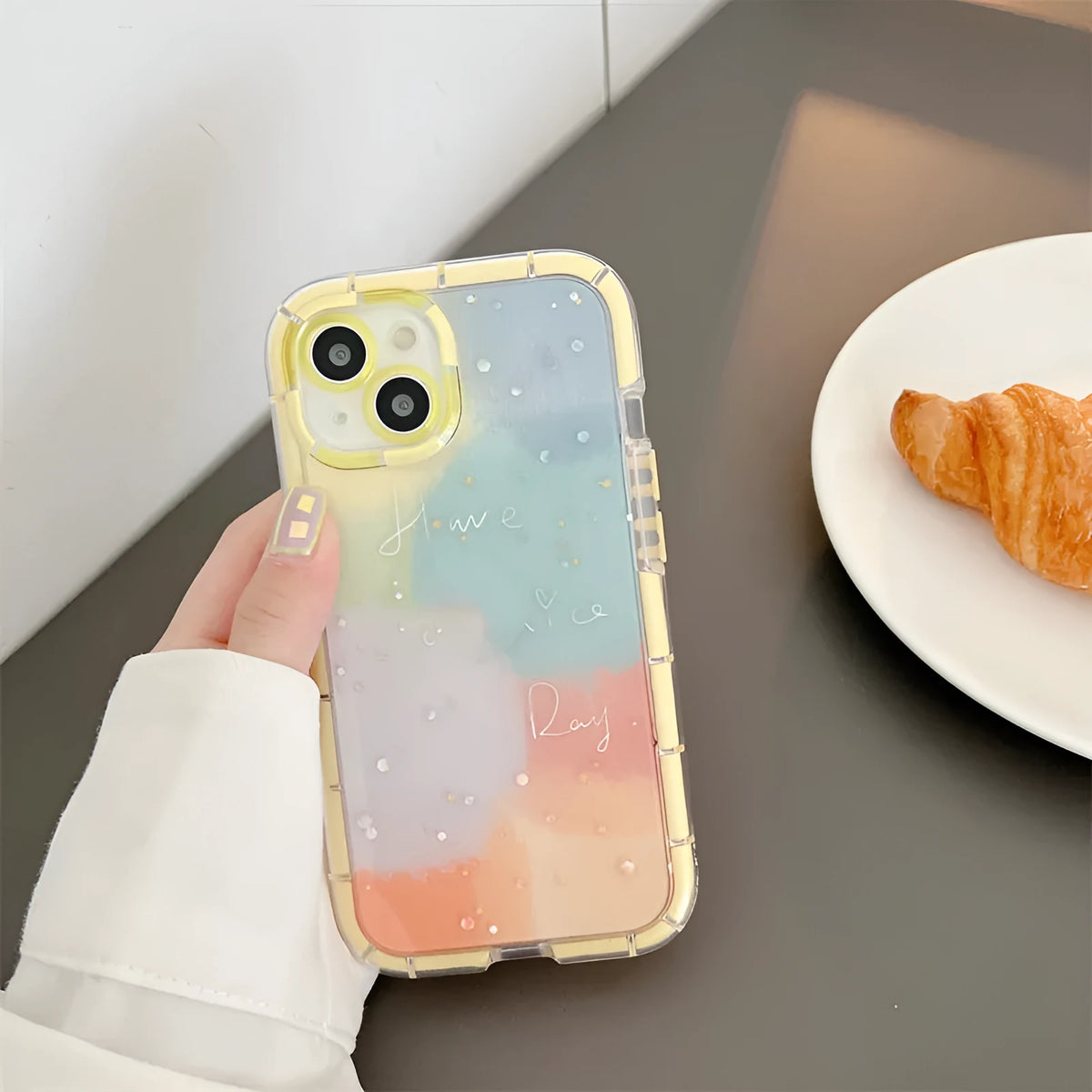 Minimalist iPhone case with a yellow edge on a phone, showing its slim TPU construction.