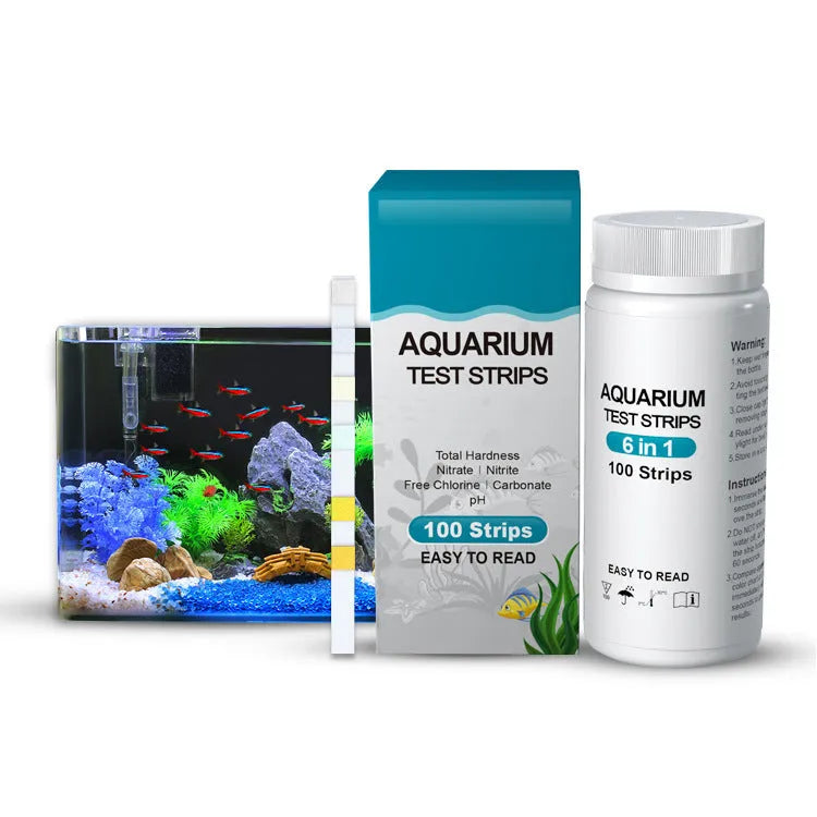Six-in-one aquarium water quality test paper on a white surface, showing colour pads for total hardness, nitrate, nitrite, chlorine, carbonates, and pH testing